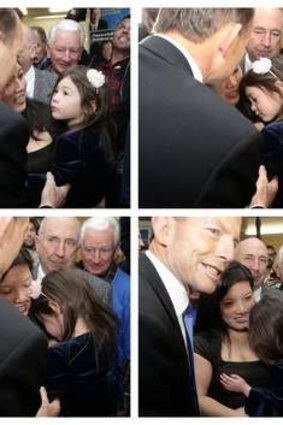 Opposition leader Tony Abbott meets 4 year old Tess Stansfield during the campaign launch for candidates Tanya Denison and Bernadette Black, in Hobart on Thursday.