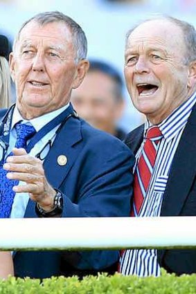 John Singleton (left, owner of More Joyous) and Gerry Harvey (part owner of All Too Hard) cheer on their horses in the All Aged Stakes.