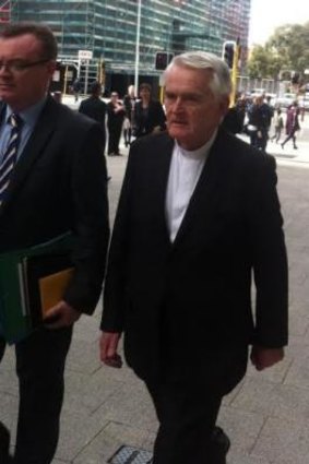 Bishop Max Davis leaves court on Friday.