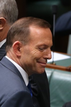 Prime Minister Tony Abbott passes Communications Minister Malcolm Turnbull at the end of question time  on Thursday.