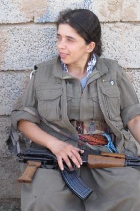 A PKK fighter rests after a night on the frontline.