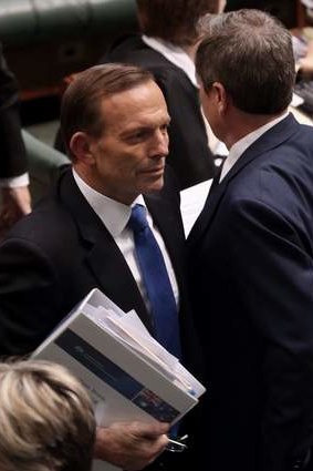 Prime Minister Tony Abbott and Opposition Leader Bill Shorten pass after a division in Parliament House. Photo: Andrew Meares