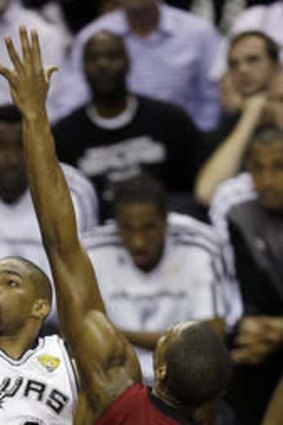 On fire: San Antonio Spurs guard Gary Neal shoots against Miami Heat's Chris Bosh.