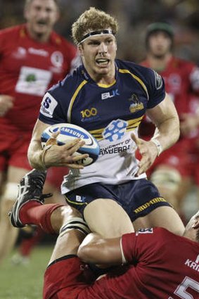 David Pocock of the Brumbies is tackled by Rob Simmons of the Reds.