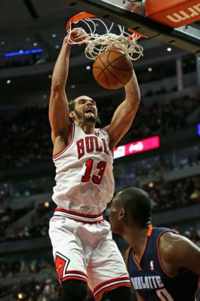 Chicago centre Joakim Noah dunks the ball over Bismack Biyombo of the Charlotte Bobcats at the United Center in Chicago. The Bulls defeated the Bobcats 103-97.