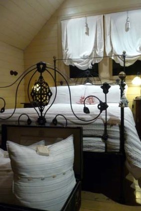 Old-world charm ... a cast-iron bed and Edwardian details give Gardeners Cottage a homey feel.
