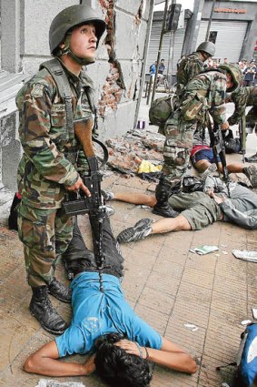 Chilean soldiers arrest looters in Concepcion.