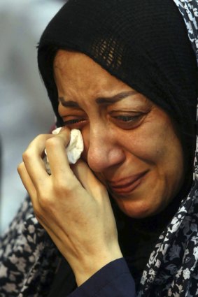 French embassy staff member Nazak Afshar wipes away tears.