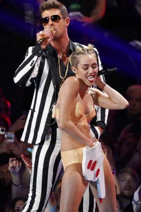 Eccentric routine: Miley Cyrus grinds up against Robin Thicke.