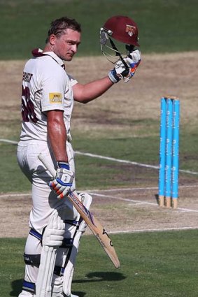 Peter Forrest acknowledges the applause after he reached his century.
