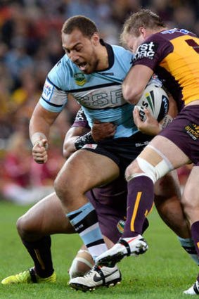Size matters: Cronulla big man Sam Tagataese powers forward against Brisbane.