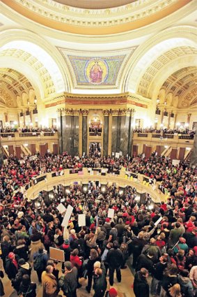 Opponents of Governor Scott Walker’s bill stormed the state legislature in Madison, Wisconsin.