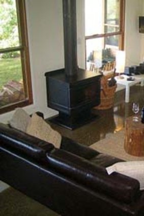 Cosy corner ... a wood stove is at the centre of Themeda Cottage's open-plan living area.