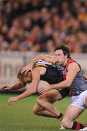 Essendon’s Michael Hibberd takes on Richmond opponents Luke McGuane, Ty Vickery and Jack Riewoldt.