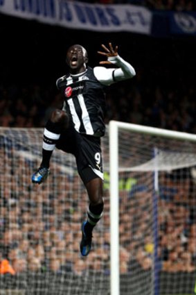 Newcastle striker Papiss Demba Cisse celebrates his astonishing goal, which appeared to defy the laws of physics.