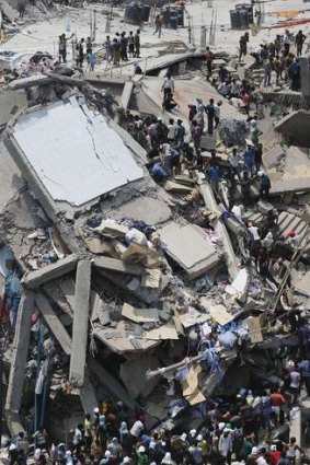 People rescue workers trapped under rubble at the Rana Plaza building after it collapsed, in Savar, 30 km outside Dhaka.