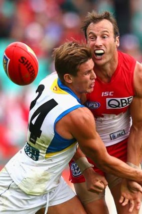 Gold Coast's David Swallow lays a tackle on Sydney veteran Jude Bolton.