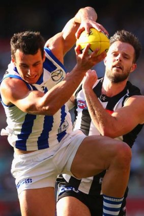 Robbie Tarrant of the Kangaroos marks in front of Nathan Brown of the Magpies.