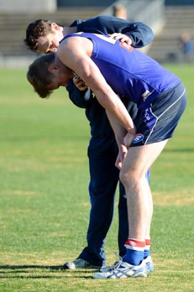 Jordan Roughead is in pain after seeming to injure his right shoulder. Thankfully for the injury-hit Dogs, he returned soon after.
