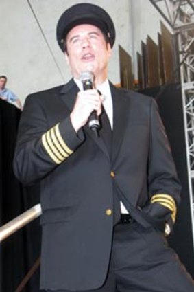 John Travolta performs "Summer Nights" for the Qantas 90th birthday party crowd.