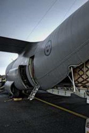 Staff load a Hercules aeroplane with relief equipment at Orebro airport in central Sweden to support the UN disaster relief work in the Philippines.