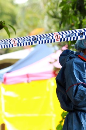 Forensic officers collect evidence at the memorial for eight children killed in Cairns.