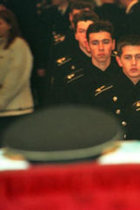 Cadets file past an officer's coffin.