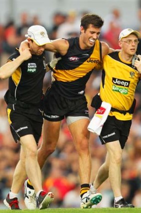 Adding injury to insult: Tiger Alex Rance is assisted from the field injured during the game against the Gold Coast.