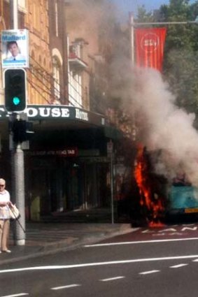 Smoke pours from the bus as it burst into flames. <i>Photo: Mags King</i>