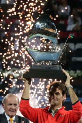 Roger Federer celebrates with his trophy after defeating Tomas Berdych 3-6, 6-4, 6-3.