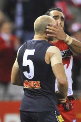 Up close: Chris Judd and Sydeny ace Adam Goodes.