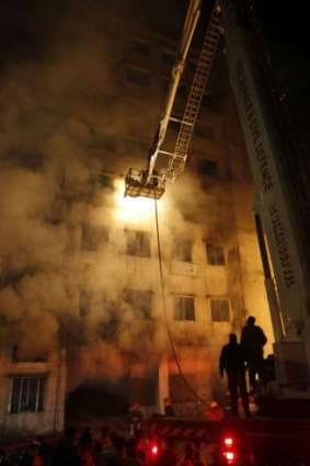 Bangladeshi firefighters trying to extinguish a fire at the nine-storey Tazreen Fashion plant in Savar, north of Dhaka.