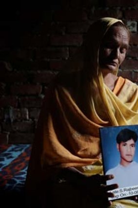 The ultimate cost: Drug widow Darshan with a photo of her dead son Raju.