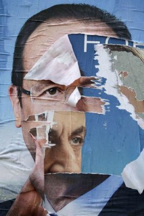 Vying for attention: Campaign posters for Nicolas Sarkozy and Francois Hollande in France.