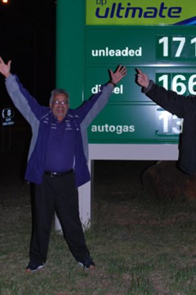 They're coming: Freo fans make the most of a petrol stop in Norseman to stretch the old legs (and arms).
