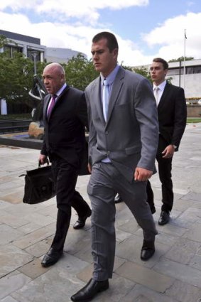 Lawyer Francis Cahill, walks from the court with the two convicted cadets: Dylan Deblaquiere, right and Daniel McDonald, centre.