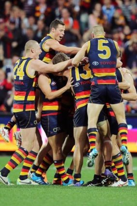 The Crows celebrate with Ben Rutten after he kicked a goal.
