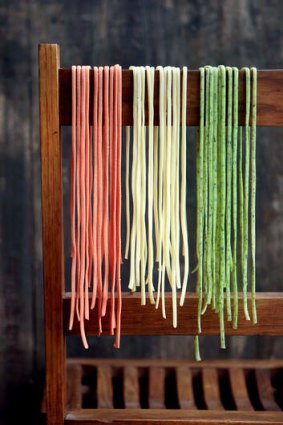 Fresh pasta hanging over a wooden chair.