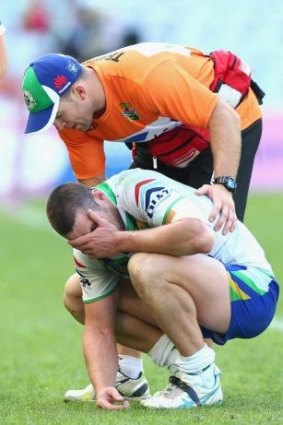 Shaun Fensom reacts after injuring his elbow against Souths.