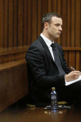 Taking notes: Oscar Pistorius in court.