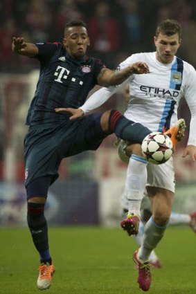 Manchester City's Edin Dzeko (R) vies with Bayern Munich defender Jerome Boateng.