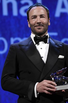US director Tom Ford holds the Silver Lion Grand Jury prize for his movie ' Nocturnal Animals ' during the awards ceremony of the 73rd Venice International Film Festival.