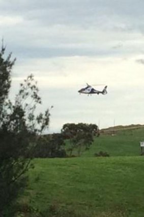 A police helicopter lands at the Hampton Park site.