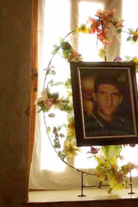 A framed photo of Reza in the family home.