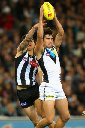 Port's Chad Wingard takes a strong mark ahead of Marley Williams of the Magpies.