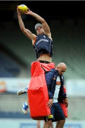 Chris Judd flies high at training.