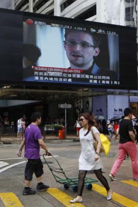 In hiding: Edward Snowden, on a Hong Kong shopping mall TV.