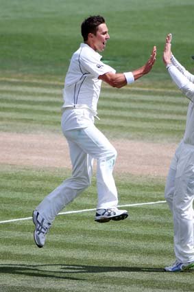 Trent Boult celebrates with Kane Williamson after taking the wicket of West Indies one-drop Kieran Powell.