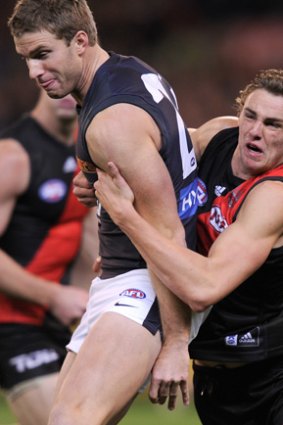 Gotcha: Essendon’s Joe Daniher tackles Carlton’s Lachie Henderson during their clash at the MCG.