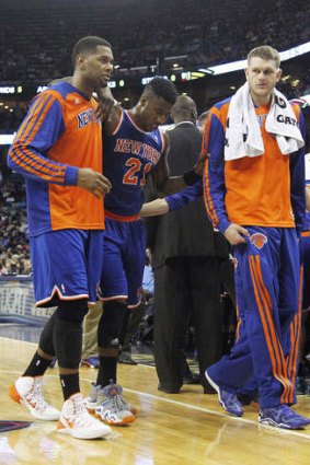New York Knicks shooting guard Iman Shumpert is helped off the court after being injured during the game against the Pelicans in New Orleans.